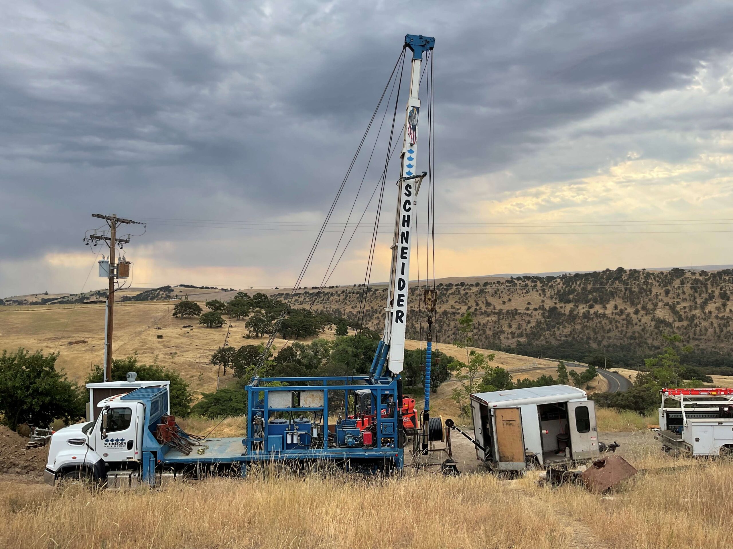 Schneider Water Services Well Rehabilitation Schneider Water Services Well Rehabilitation project showing a truck with the Schneider logo on a hill with the sun setting